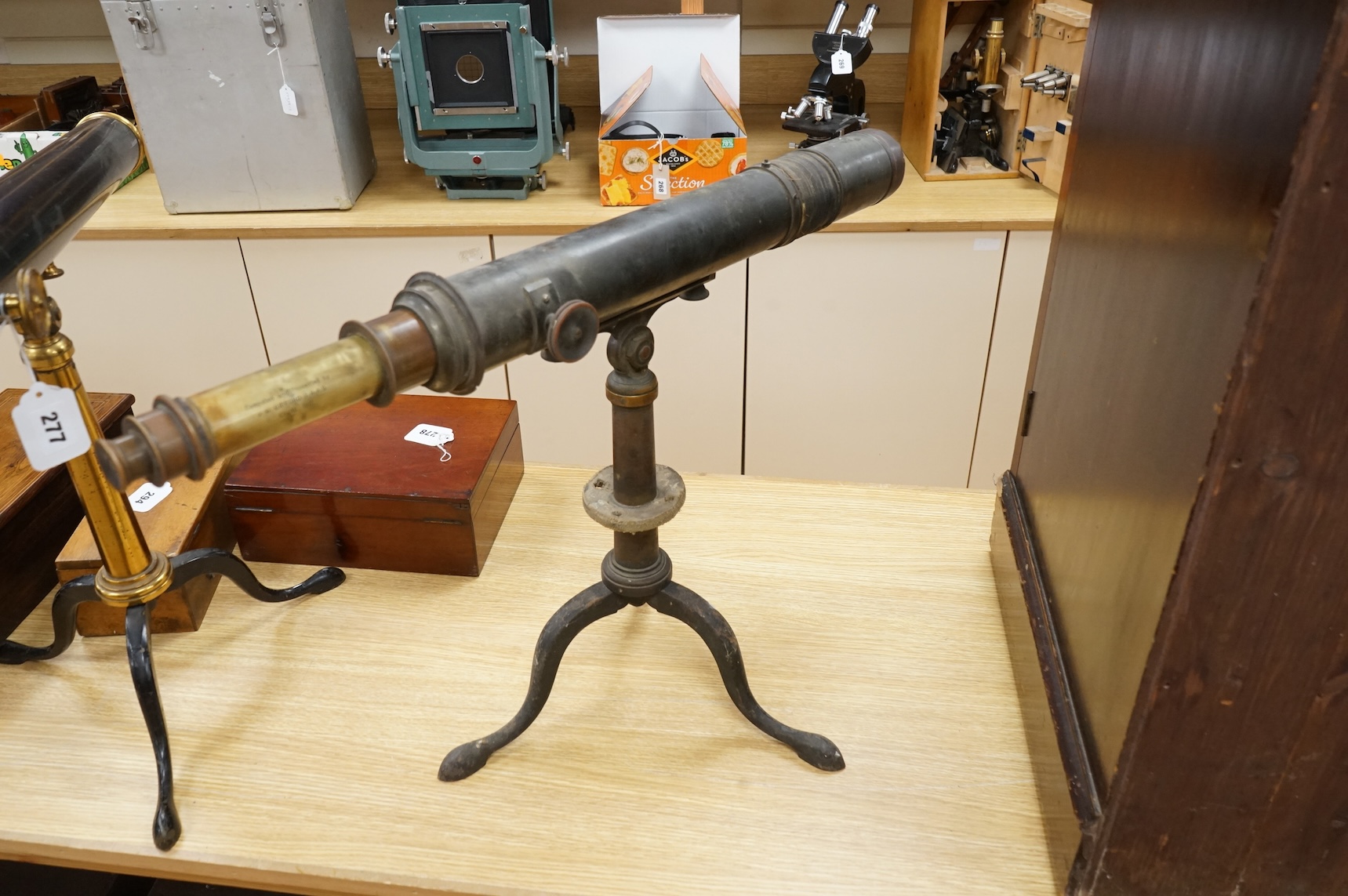 An early 20th century brass two draw telescope on tabletop tripod stand, with engraved dedication; ‘ Computed and Presented by J.W. Gifford. F.R.A.S. Chard 1917’, 73cm long, 48cm high on stand.